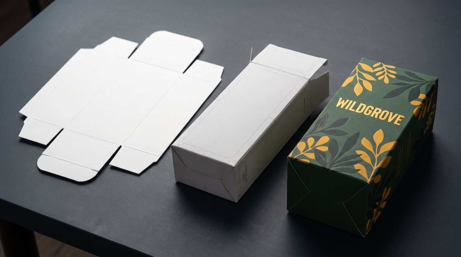 Structural packaging sample stages: flat die-cut blank, unprinted folded carton, and fully printed appearance prototype